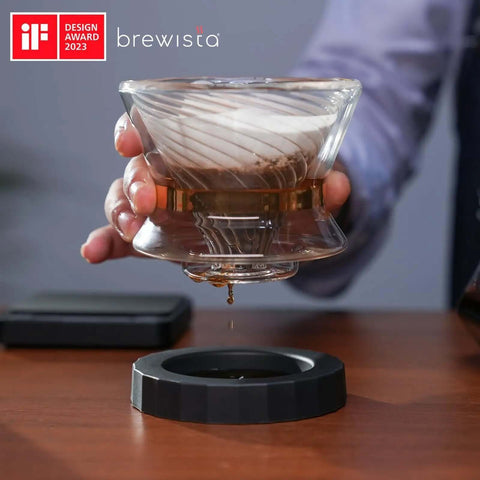 Tornado Duo Pour Over Coffee Dripper Barista Grade With Double Wall Glass Insulated Body Easy To Clean Dripper For Home Or Office 1 To 2 Cups 18 Rib Design Slows Water For Rich Flavor And Smooth Extraction in use, showing double-walled glass and coffee dripping.