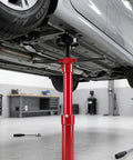 Heavy Duty Underhoist Support Stand With Dual Height Adjustments For Car Lifts And Garage Jobs Up To Three Quarter Ton Capacity supports a vehicle.