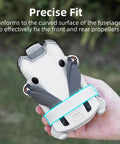 DJI Mini 4 Pro Propeller Guard Strap Holder for Secure Propeller Protection when Stowed, shown securing drone blades in hand.
