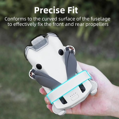 DJI Mini 4 Pro Propeller Guard Strap Holder for Secure Propeller Protection when Stowed, shown securing drone blades in hand.