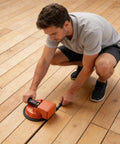 Man using Floor Patch Repair Tool With Ultra Strong Suction For Crack Filling And Leveling Laminate Tile Flooring Planks In Kitchen Bathroom Living Room Ideal For Plank And Tile Installations And Quick Diy Home Fix on wooden floor