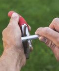 Hands using Model 905 Sharpener Carbide Stone For Pruning Shears Pro Grade Honing And Sharpening Tool on shears outside