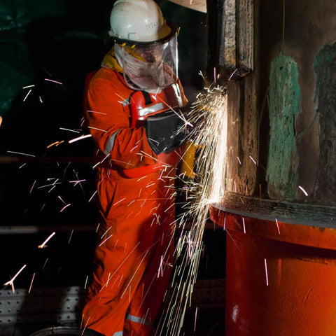 Worker using Oxy Fuel Welding And Cutting Torch Kit With X-3B Air Acetylene System on metal cylinder, sparks flying