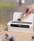Top Shelf Mini Ultrasonic Cleaner Hella Crisp 500 ML Wash Bath For Rings Glasses Watches Jewelry Razors Headphones And Dental Retainers Portable Clean Machine with a hand inserting a makeup brush.