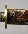 Close-up of phoenix motif on the natural grain rosewood scabbard of a Folded Steel Dao Sword With Phoenix Motif, Handmade High Carbon Blade With 32,768 Layered Steel For Superior Flex And Edge, Natural Grain Rosewood Scabbard, Traditional Craftsmanship For Collectors And Martial Arts Buffs.