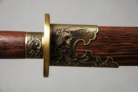 Close-up of phoenix motif on the natural grain rosewood scabbard of a Folded Steel Dao Sword With Phoenix Motif, Handmade High Carbon Blade With 32,768 Layered Steel For Superior Flex And Edge, Natural Grain Rosewood Scabbard, Traditional Craftsmanship For Collectors And Martial Arts Buffs.