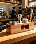 Buttery Smooth Espresso Tamper Station Crafted From Solid Natural Wood 58mm with tools on a cafe countertop.