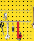 Two Pack Multi Prong Pegboard Accessories Organizer Kit With Tool Storage Hooks for workshop, holding tools against a yellow pegboard.