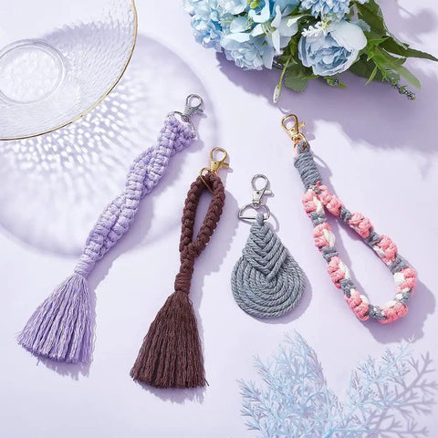 8 Set DIY Macrame Wristlet Keychain Kit For Adults Colorful macrame cord keychains laid out on a flat surface with tassels and clasp details.