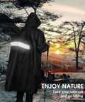 Person hiking at sunset wearing Waterproof Rain Jacket For Men And Women Lightweight Hooded Long Sleeve Packable Windbreaker Poncho.