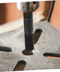 Hydraulic Heavy Duty Workhorse Knockout Punch Driver Kit for Metal Sheets in use punching a clean hole in a metal sheet