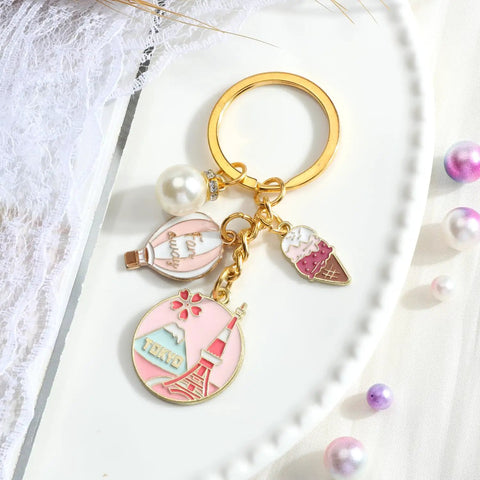 Tokyo Travel Keychain With Hot Air Balloon Ice Cream And Pearl Charms For Keys Cute Souvenir For Women Mt Fuji Silhouette Engraved Design Perfect Travel Keepsake For Japan Trips, shown with charms on white background
