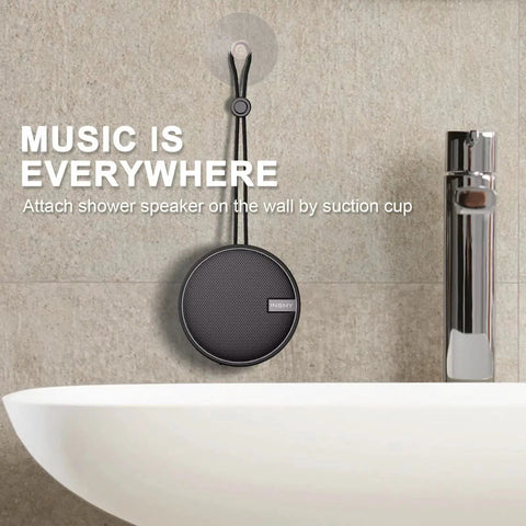 Rugged IP67 Waterproof Bluetooth Speaker With Submersible Design hanging on bathroom wall via suction cup.