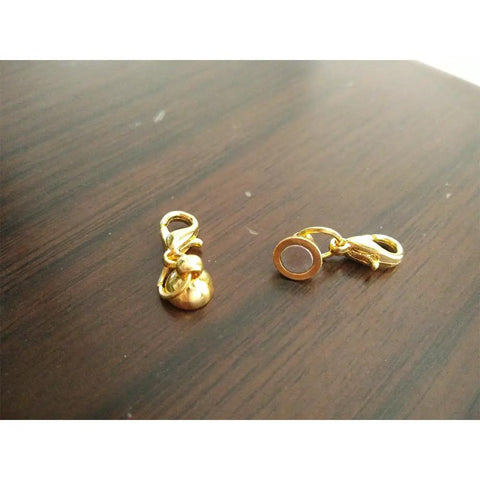 Close-up of two gold color magnetic clasps from 24 Piece Magnetic Lobster Clasps Set In Gold Color And Silver Color For Jewelry Making.