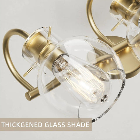 Two-Light Gold Bathroom Vanity Light Fixture With Clear Globe Shades, close-up showing bulb close to globe, E26 base detail