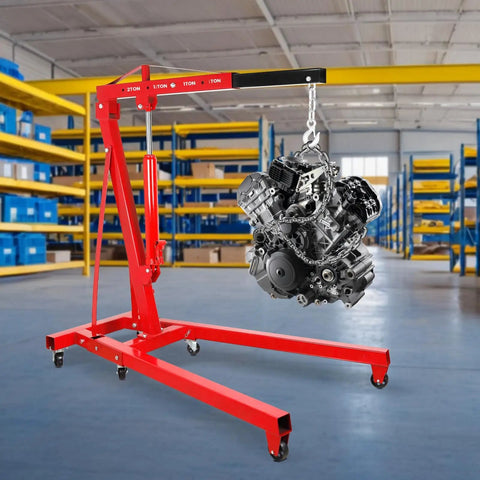 Heavy Duty 2 Ton Engine Hoist With Retractable Telescopic Boom and Six Rolling Caster Wheels, lifting an engine in a workshop.