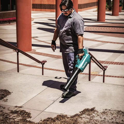 Man using 18V LXT Brushless Cordless Blower With Cruise Control, Variable Speed Trigger, And Speed Lock For Continuous Operation, Inline Fan Design For Superior Balance And Ergonomics, Tool Only on steps