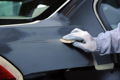 Hand using Soft Hand Sanding Sheets 4.5 By 5 Inch Grit 240 On Perforated Roll 200 Sheets for smoothing car surface
