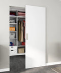30X84 Inch Flush White Primed Barn Door With Invisible Hidden Track And Soft Close Hardware Kit in modern closet setting.