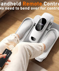 Person using Under Desk Elliptical Pedal Exerciser For Home Office with remote control, showing socks on pedals, boosting circulation.