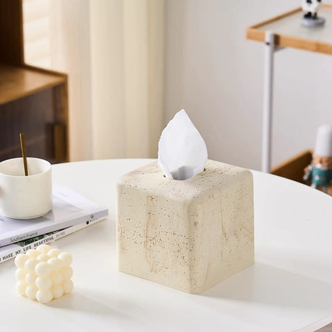 Heavy Resin Tissue Box Cover With Travertine Texture For Home Decor on a white tabletop with coffee cup and books.