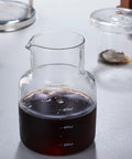 Premium Cold Brew Drip Tower With Adjustable Flow Control Borosilicate Glass Carafe with cold brew coffee inside, 600ml size.
