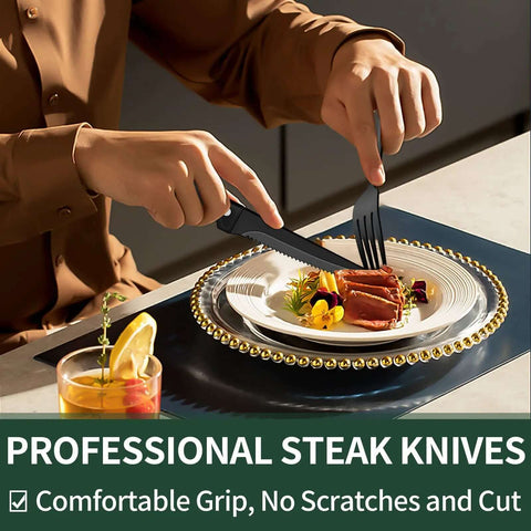 Person using black flatware set for 4 with steak knives from 24 piece stainless steel cutlery on elegant dinner plate