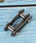 Heavy Hitter Stainless Steel Chain Master Links For Bikes And Cycles, close-up view on a blue background.