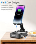 Foldable Phone Stand With Bluetooth Speaker And Built In Charging Station 3 In 1 Desk Gadget on wooden desk