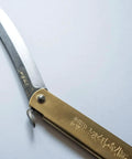 Dope Japanese Folding Knife With Blue Paper Steel Blade, 3mm Thick, 120mm Closed, 220mm Open, Brass Handle, High Edge Retention, Nagao Seisakusho Craft, EDC Ready Everyday Carry Knife, showing brass handle and open blade close-up on a light background