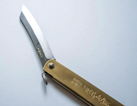 Dope Japanese Folding Knife With Blue Paper Steel Blade, 3mm Thick, 120mm Closed, 220mm Open, Brass Handle, High Edge Retention, Nagao Seisakusho Craft, EDC Ready Everyday Carry Knife, showing brass handle and open blade close-up on a light background