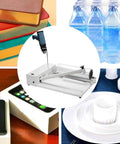 Heavy Duty Industrial Shrink Wrap Machine With Heat Sealing Gun And Thermal Wrapper on a table with books, water bottles and packaging.