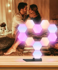 Lit Smart Hexagon LED Light Kit, 10 Pack WiFi Wall And Tabletop Blocks on tabletop with mood lighting in cozy setting