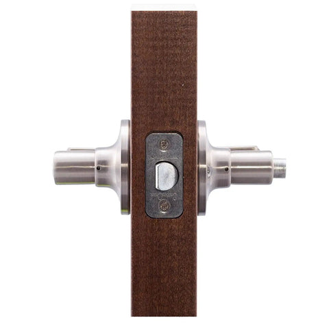Privacy Lever Door Handle With Push Button Lock, Reversible For Left Or Right Hinging in satin nickel on wooden panel.