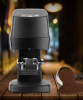 Top Shelf Electric Coffee Powder Tamper 58mm Portafilter Automatic Espresso Press on a wooden table with coffee grounds.