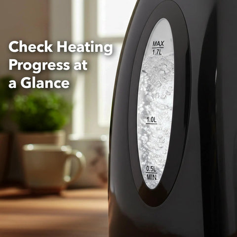 Electric Kettle 1.7 Liter Fast Boil Water Heater For Coffee Or Tea BPA Free With Water Level Gauge Auto Shut Off Boil Dry Protection Indicator Light Removable Filter Black side view showing boiling water and level gauge.