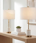 27 Inch Marble And Brass Gold Table Lamps Set Of 2 With Crystal Column Design White Linen Drum Shades on wooden table