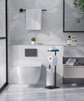 Bathroom with free standing toilet paper holder stand with rustproof metal construction for four rolls, anti-slip base, and built-in shelf.