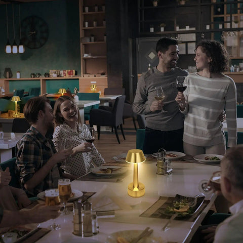 Cordless Gold Battery Operated Table Lamp For Dining Ambience in a restaurant setting with people enjoying a meal