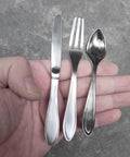 Close-up of 3 Piece Funny Knife Spoon Fork Shape Cabinet Pulls Set For Kitchen Cupboard And Drawer Handles shown in hand