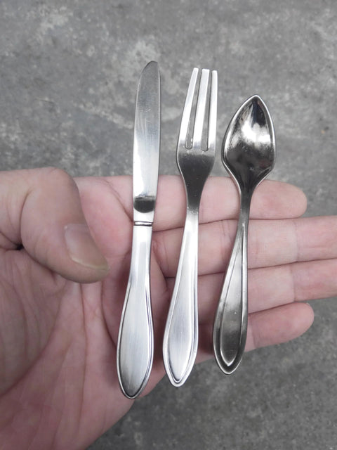 Close-up of 3 Piece Funny Knife Spoon Fork Shape Cabinet Pulls Set For Kitchen Cupboard And Drawer Handles shown in hand