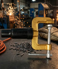Dope Heavy Duty Grounding Clamp With Screw For Welders And Workshops Featuring Secure Insulated Handle and brass body on a workshop table.