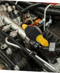 Portable Transfer Pump For Trucks, Cars, And Boats - Manual Siphon Pump For Fast Liquid Transfer, Easy Extraction, No Spill Design, Anti Leak Air Feature, Great For Yachts And Heavy Equipment Tools. Black and yellow hose fitting on engine assembly