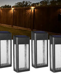 4 Pack Solar Fence Lights Outdoor Waterproof Aluminum Frosted Glass Post And Wall Lamps illuminating a yard at night