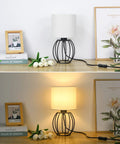 Two Modern Table Lamps For Bedroom Nightstand Dorm Or Office With White Fabric Shade And Black Metal Base Compact Desk Lamps Great For Reading Bulbs Not Included Ideal For Bedside Lighting Study Desks And Cozy Living Room Ambiance shown off and on on a wooden surface.