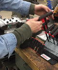 Person handling Power-T T-Handle Ball Hex Allen Wrench 3/32 Inch near tool rack in workshop, showing ergonomic handle and alloy construction.