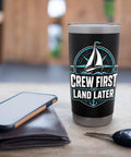 Crew First Land Later Sailboat Stainless Steel Insulated Tumbler for Coastal Sailing and Regatta Days on table with phone