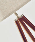 Close-up of walnut brown wood legs and cream drum shade on Tall Tripod Floor Lamp With Wood Legs And Cream Drum Shade, Modern Mid Century Style LED Lamp