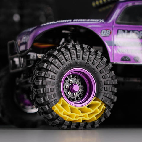 Close-up of silicone rubber inserts and S5 all-terrain tires for 1/18 TRX4M RC crawler with aggressive side lug grip