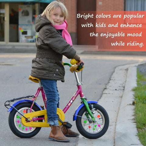 Child riding bike with colorful 210 Pcs Bike Wheel Spokes Beads Set For Kids - Colorful Plastic Clip Beads in star shapes